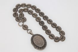 An antique silver Victorian locket and chain
