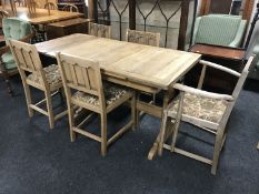 An oak refectory dining table together with five chairs (one carver and four singles)
