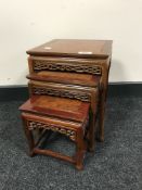 A nest of three miniature hardwood Oriental tables