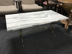 A rectangular white marble topped table on brass base