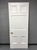 A painted interior panel door with brass handle