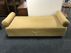 A mid twentieth century storage day bed with two bolster cushions