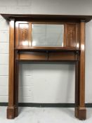 A Victorian inlaid mahogany mirrored fire surround