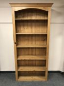A pine open bookcase with adjustable shelves