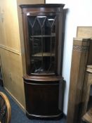 A mahogany corner display cabinet
