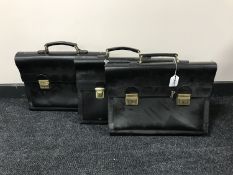 Three black leather briefcases