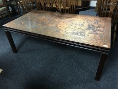 A copper topped coffee table depicting a map of the world