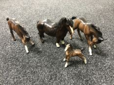 Three brown gloss Beswick standing foals and a Royal Doulton foal