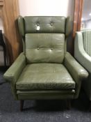 A mid 20th century Danish green buttoned leather wing backed armchair