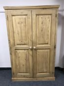 A pine double door pantry cupboard