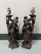 A pair of carved hardwood Oriental table lamps (2)