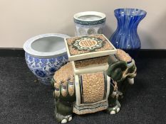 A pottery elephant plant stand together with a blue and white oriental style fish bowl,