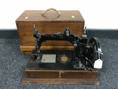 A vintage Wheater and Wilson hand sewing machine in mahogany case