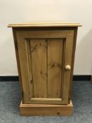 A pine single door cabinet