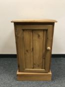 A pine single door cabinet