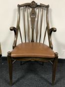 A continental oak spindle backed elbow chair
