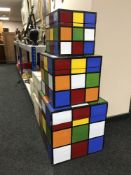 A set of three graduated Rubix Cube style storage boxes