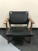 A mid 20th century teak framed black vinyl armchair