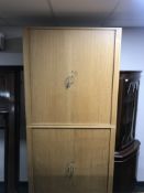 A mid twentieth century double office cabinet with shutter doors