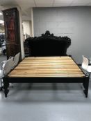 A pine 6' bed frame and a black Rococo style headboard in black button fabric