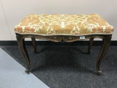 A carved walnut dressing table stool