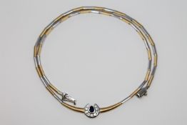 An 18ct white and yellow gold diamond and sapphire set necklace,