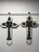Six cast metal crucifixes mounted on boards