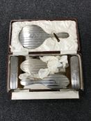 An early twentieth century six piece silver backed dressing table brush set, cased.