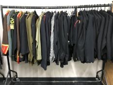 A rail of military tunics and jackets CONDITION REPORT: Apologies but we are unable