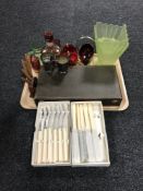A tray of glass liqueur decanters and glasses, cutlery, plated napkin ring,