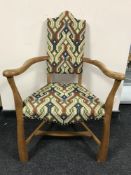An early twentieth century continental oak armchair upholstered in multi-coloured print