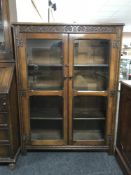 A carved oak double door bookcase