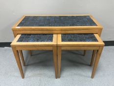 An oak tiled coffee table together with pair of matching lamp tables