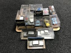 A tray of nineteen James Bond die cast vehicles part in plastic display cases