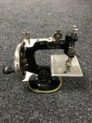 A miniature Singer hand sewing machine
