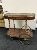 An inlaid two tier drinks trolley with brass gallery