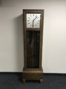 A mid 20th century oak cased regulator clock with pendulum and weights