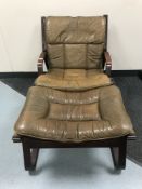 A Danish stained beech framed brown leather chair and footstool