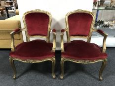 A pair of gilt salon armchairs upholstered in red dralon fabric