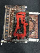 A hearth rug together with a blue silk finished prayer rug and two fringed woollen rugs