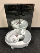 A Beurer foot bath together with contemporary mirrored bathroom cabinet