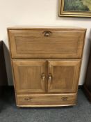 An Ercol elm cocktail cabinet