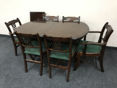 An inlaid mahogany twin pedestal dining table with leaf and six chairs (two carvers plus four