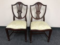 A set of four mahogany shield back dining chairs