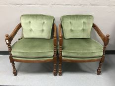 A pair of continental mahogany armchairs with green dralon cushions