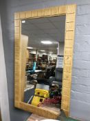 A blond oak framed mirror