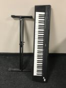A Yamaha portable grand MP-30 electric keyboard on stand