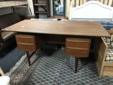 A mid 20th century teak twin pedestal desk