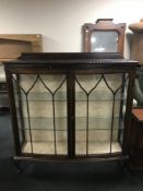 A mahogany double door display cabinet on claw and ball feet