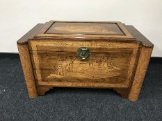A carved camphor wood chest with lock